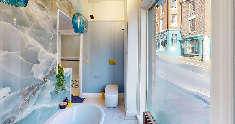 A bathroom featuring a blue marble wall and a stylish bathtub