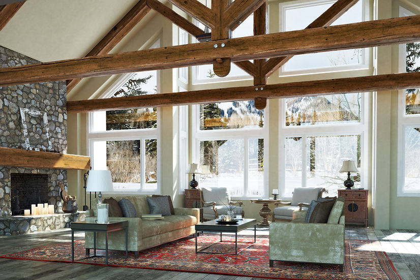 A large great room with a stone fireplace, furniture, and large exposed beams.