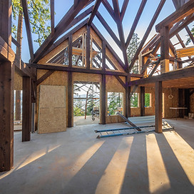 A bare timber frame structure.
