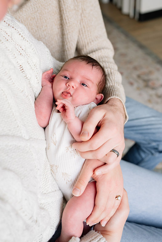 A newborn girl in the arms of her dad