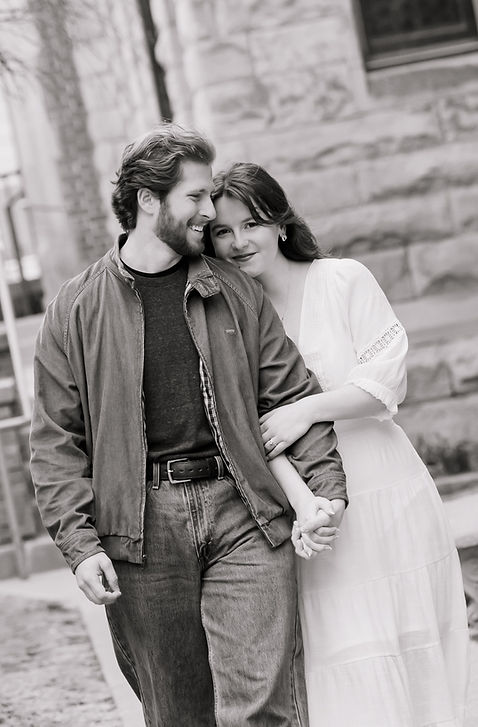 couple holding arms walking