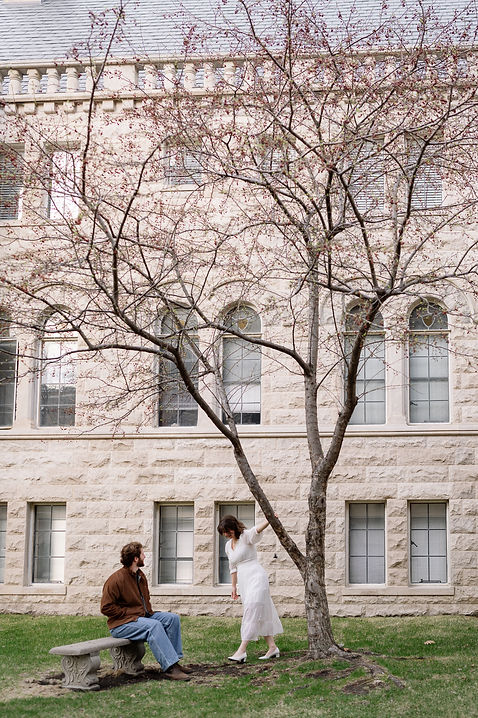 woman swinging on tree looking at man sitting on bench