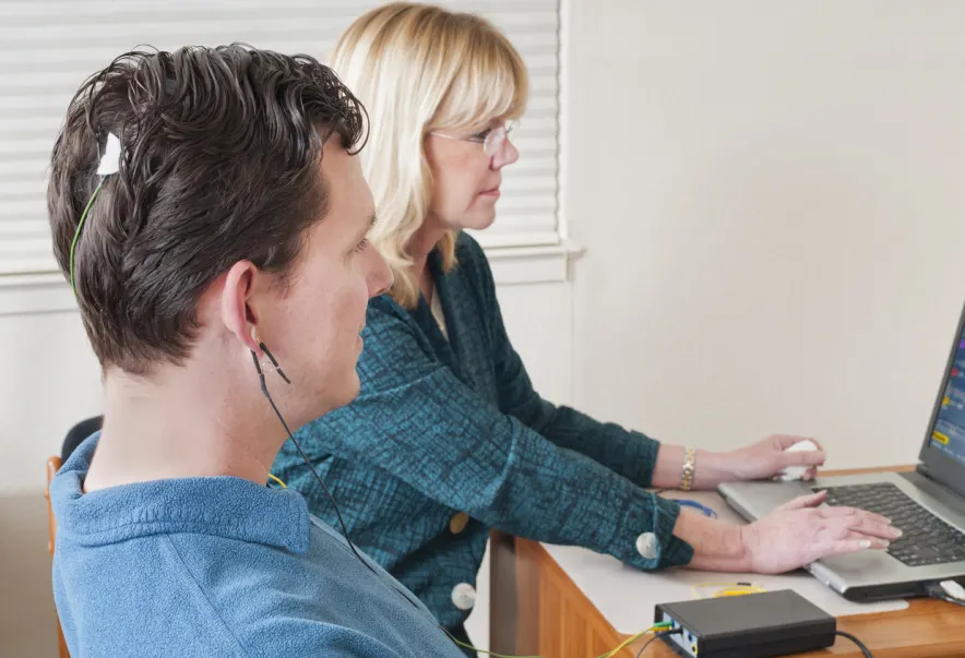 Clinician showing clients results from neurofeedback