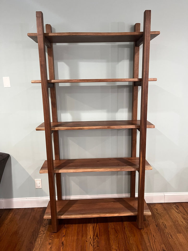 Front view of the live edge black walnut shelving unit with five shelves on solid walnut uprights, Glen Cove, NY