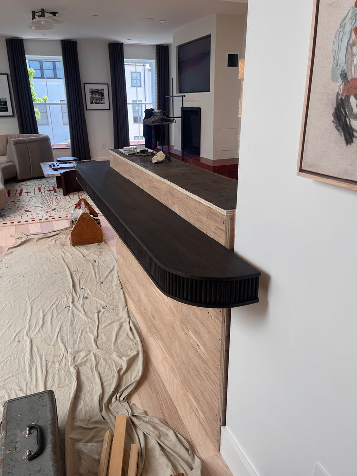 Walnut bar with tambour looking into the living room of a Brooklyn brownstone.