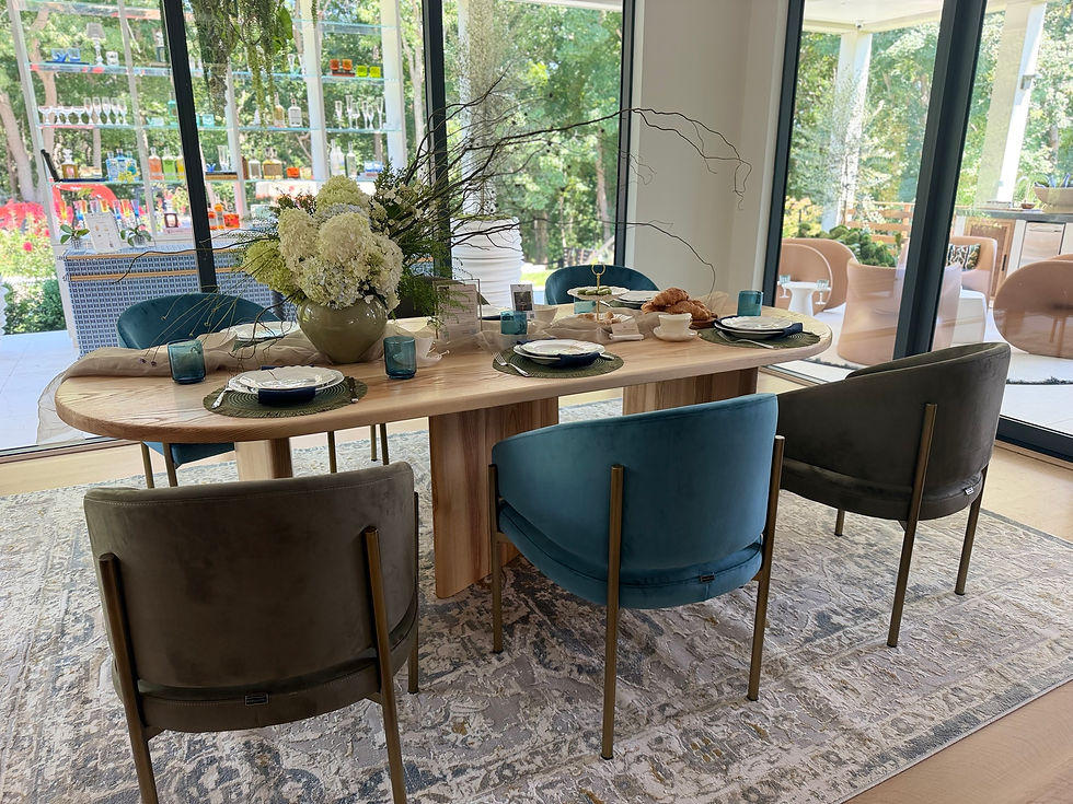 Pratt Oval solid ash dining table on three sculptural pedestals with blue and olive velvet chairs at Holiday House Hamptons, Bridgehampton.