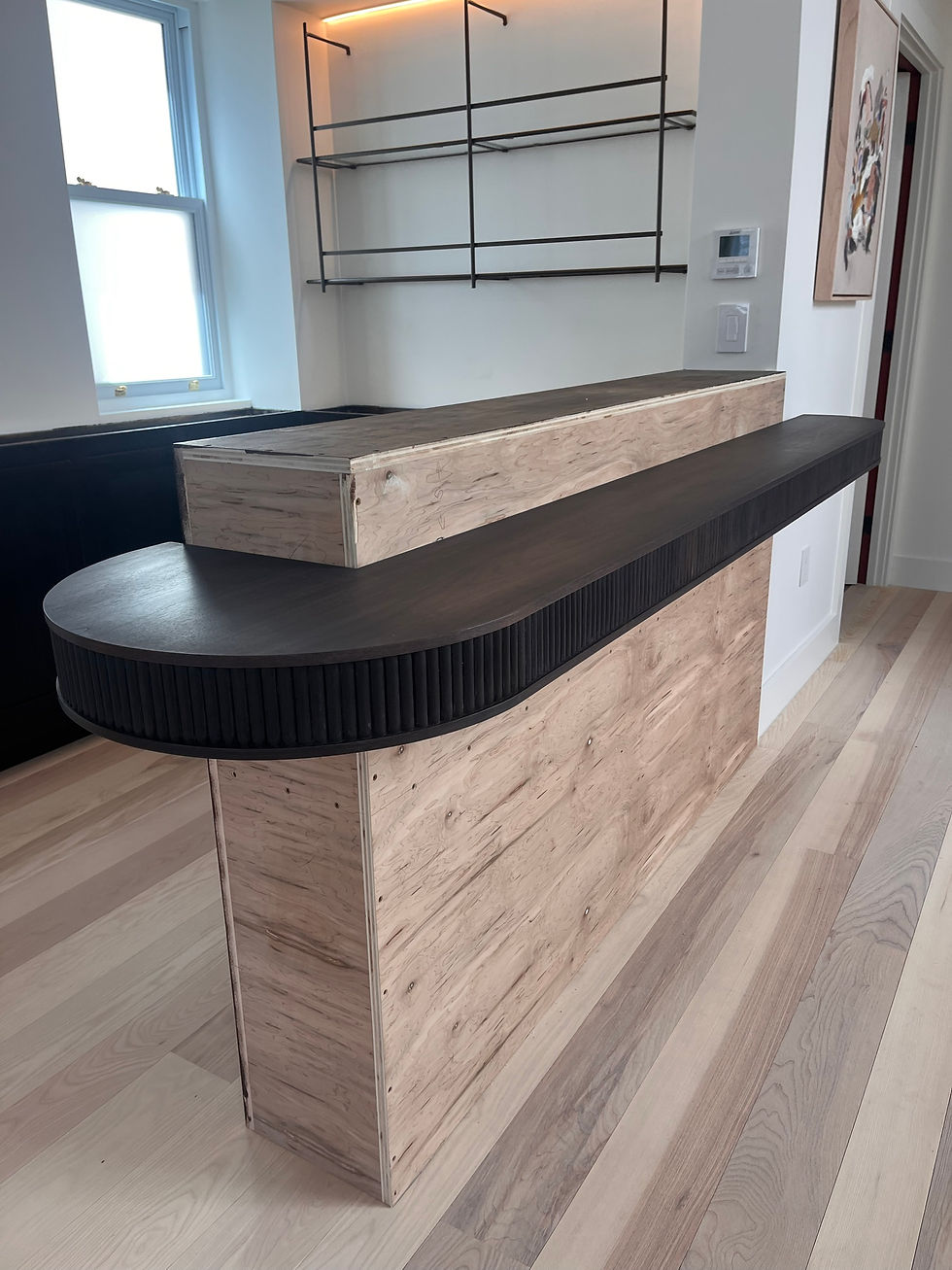 Iron walnut bar top with a tambour front, installed in a renovated Brooklyn brownstone.