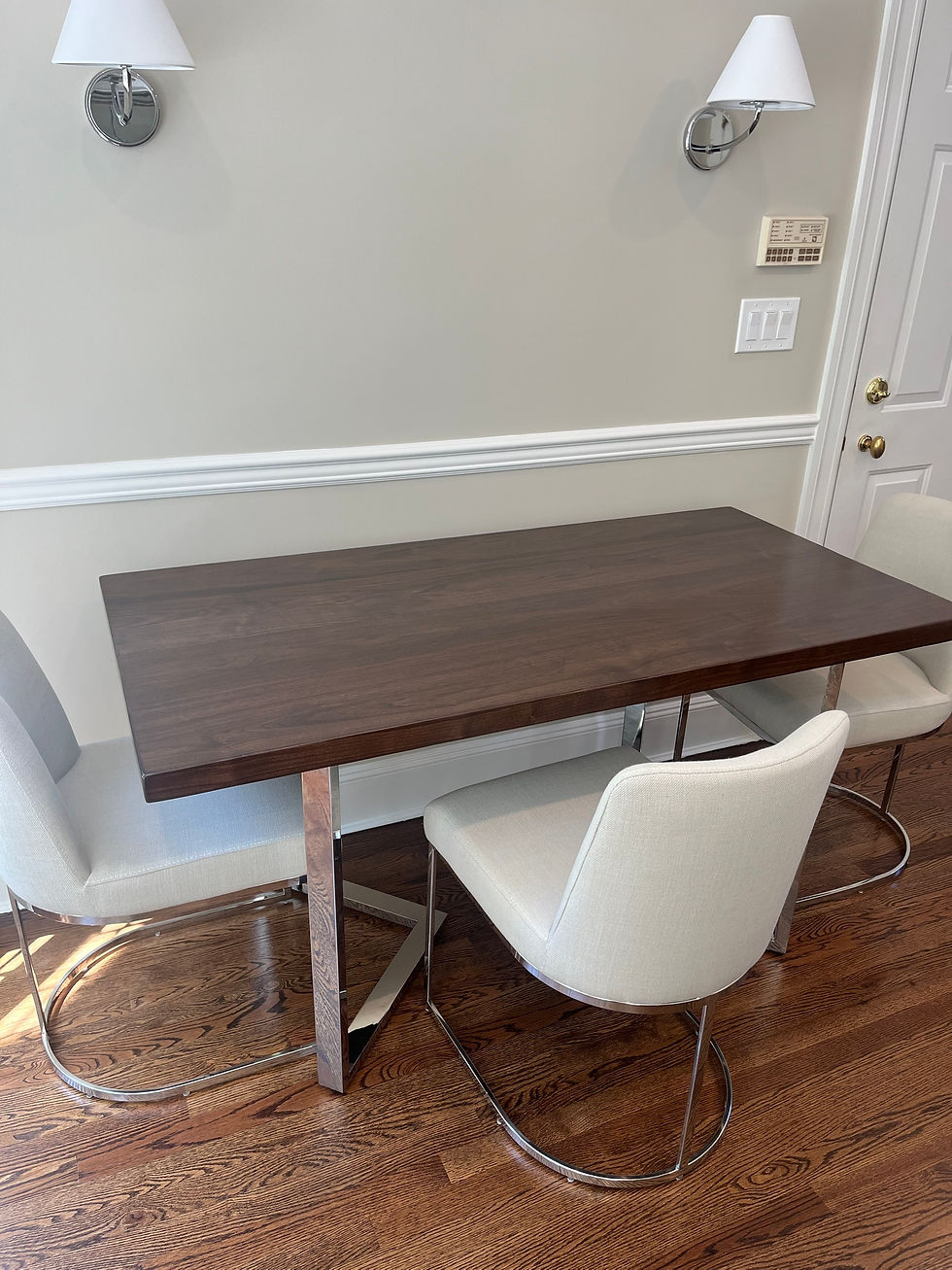 Black walnut kitchen table on custom polished chrome legs with cream upholstered chairs, Goldens Bridge, New York.