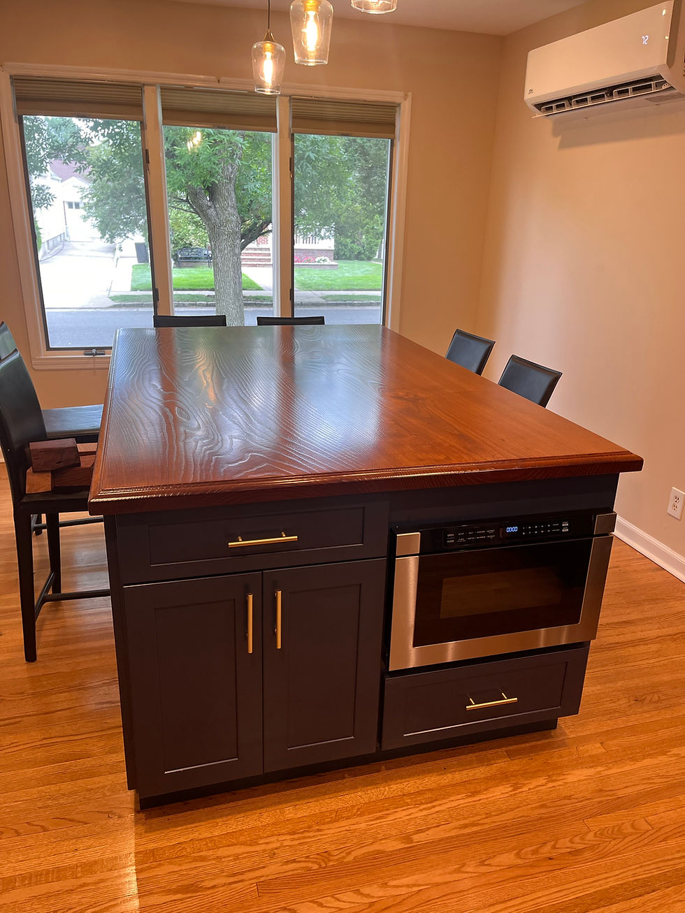 Solid wood kitchen island countertop on navy shaker cabinets with seating, New Hyde Park, NY