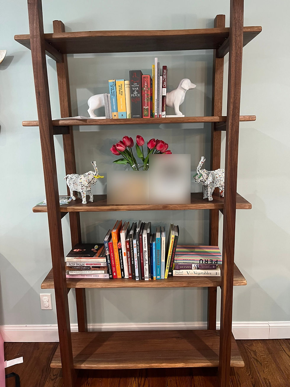 Custom solid walnut open shelving unit with five live edge shelves in a Glen Cove, New York home.