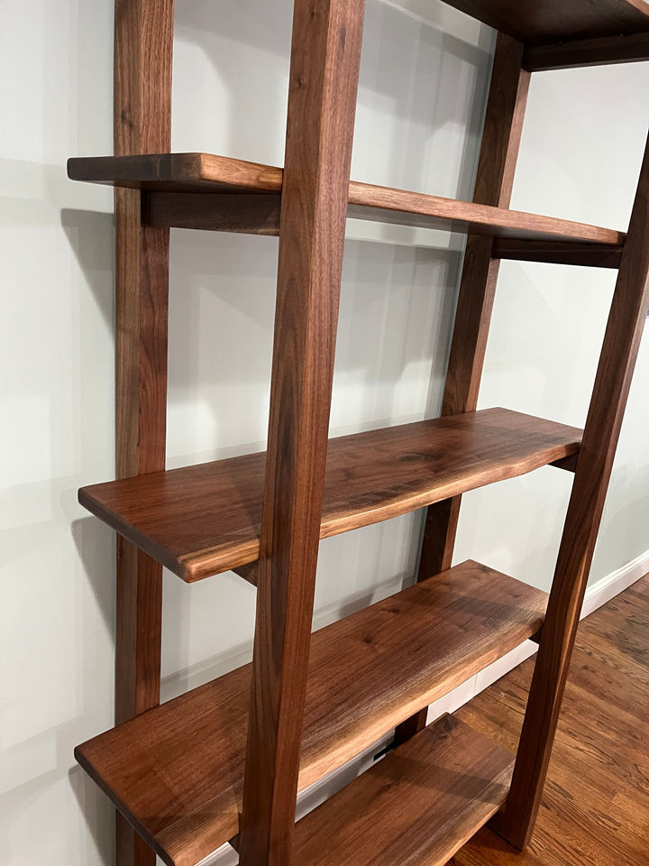 Close view of the live edge walnut shelves set into solid walnut uprights, finished with Odie's Oil, Glen Cove, NY