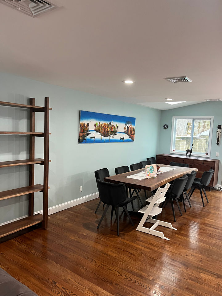 Live edge black walnut shelving unit, live edge walnut dining table and walnut sideboard by Sound Designs in a Glen Cove, NY home