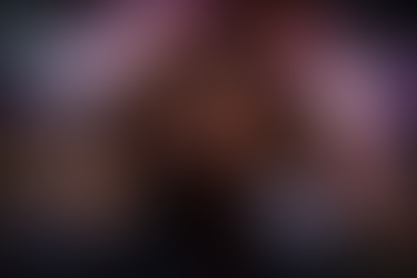 A landscape digital image of a woman holding her head in visible distress, eyes closed as swirling, luminous colors move behind her, symbolizing confusion and sensory overwhelm.