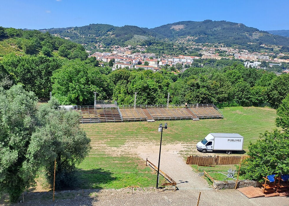 imagem vista de cima de uma aldeia, e mais perto bancada de madeira instalada num descampado