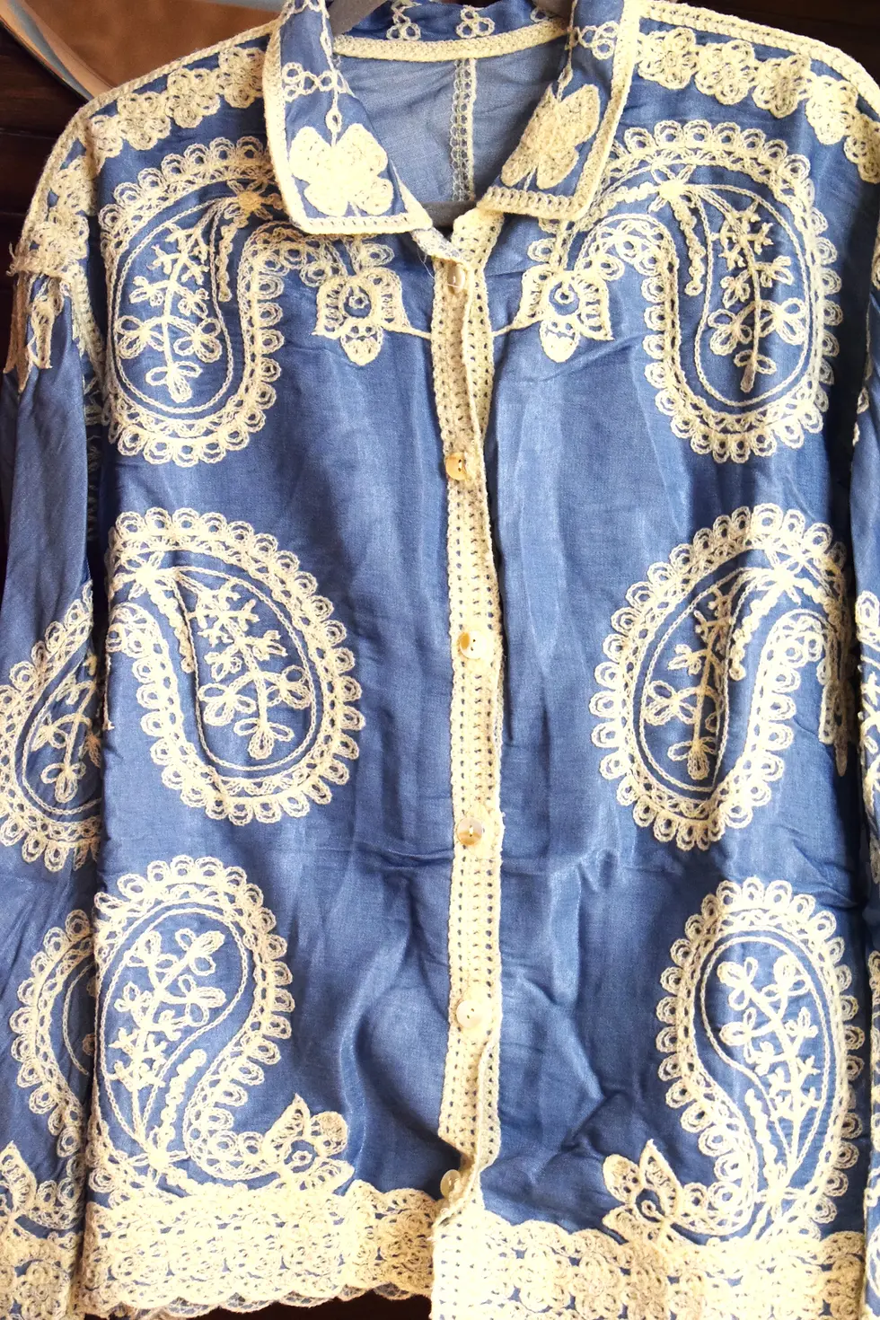 Thumbnail: Blue shirt with white paisley design and button detail visible.