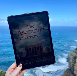 Tablet displaying "The Ascension of Greenville" is held by a hand against a cliffside backdrop with ocean waves and a clear blue sky.