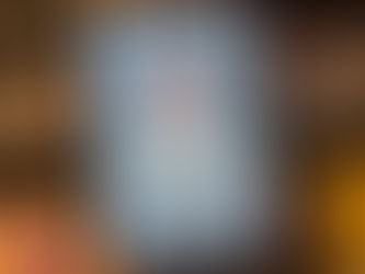 Person holding a tablet displaying Rev. Kevin T. Taylor's book "A Charge to Keep" in front of a colorful bookshelf.