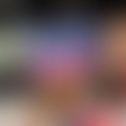 Hand holds a book titled "Christmas at the French Repair Shop" by Sophie Claire. Cozy festive illustration. Bookshelves in the blurry background.