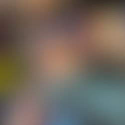 Hand holding colorful book "The Legend of Meneka" in front of a vibrant bookshelf. Elegant cover art features intricate patterns.