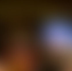 Hand holding a "Tina: The Tina Turner Musical" program with vibrant cover in a theater setting. Blurred audience and stage in the background.