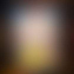 Hand holding a tablet displaying "The Gingerbread Bakery" cover with festive bakery illustration. Background shows blurred books on shelves.