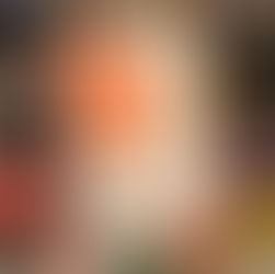 Hand holding a book titled "Best Offer Wins" by Marisa Kashino. Shelves of colorful books blur in the background, creating a cozy bookstore vibe.