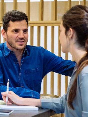 A Wix employee standing with a smartphone in a meeting room