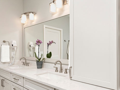 Set within a premier golf course community, this project focused on creating a spa-inspired primary sanctuary. The layout was expanded to accommodate a deep freestanding soaking tub and a generous walk-in shower. By retaining the original glass-block window to filter natural light while maintaining privacy, the design integrates new cabinetry and stone surfaces to create a serene, luxurious atmosphere.