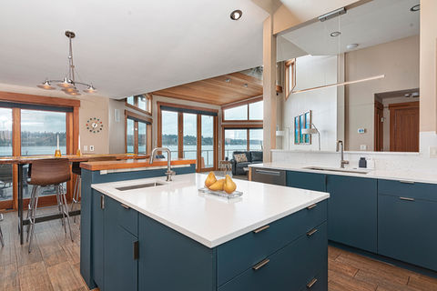 For this 1985 home, we executed a cost-effective refresh to align a traditional kitchen with the owners' mid-century vision. By updating cabinetry with cobalt blue FENIX laminate and adding quartz countertops, we bridged the gap between the existing architecture and the stunning water views, proving that a targeted refresh can yield striking, cohesive results.