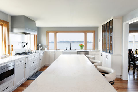 This historic 1940s Puget Sound residence was thoughtfully evolved to honor its vintage soul while embracing modern functionality. By opening the kitchen to create a vibrant social core, we introduced a chef’s dream featuring custom cabinetry and quartz surfaces. New flooring was meticulously feathered into original hardwoods, ensuring a seamless transition between the home’s storied past and its high-performing future.