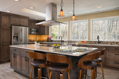 Years of planning culminated in this 1970s trilevel’s dream kitchen. By removing a central wall, we created a seamless flow between the cooking, dining, and living zones. Designed in collaboration with a passionate home cook, every cabinet was placed for peak efficiency, while a new window above the prep sink frames tranquil views of the surrounding treetops.
