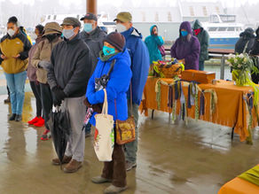people standing together under shelter for service
