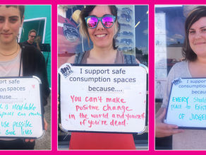 3 women holding signs