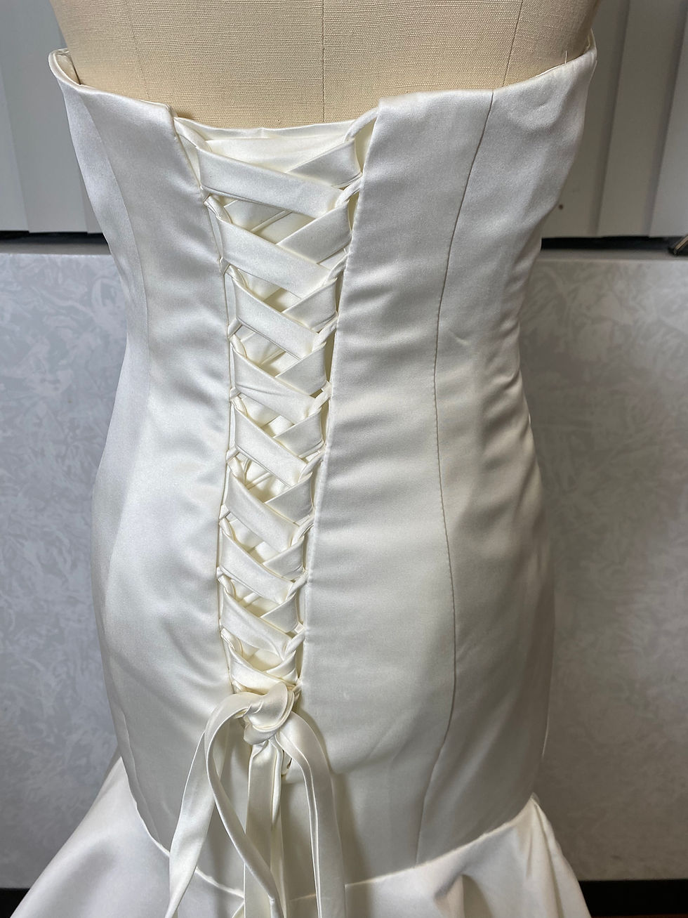 Thumbnail: Satin mermaid strapless gown on form back detail