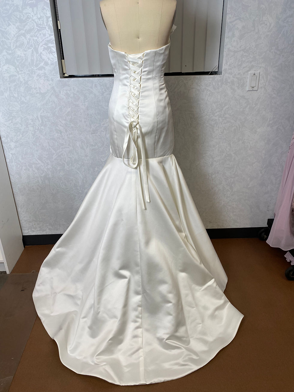 Thumbnail: Satin mermaid strapless gown on form back view