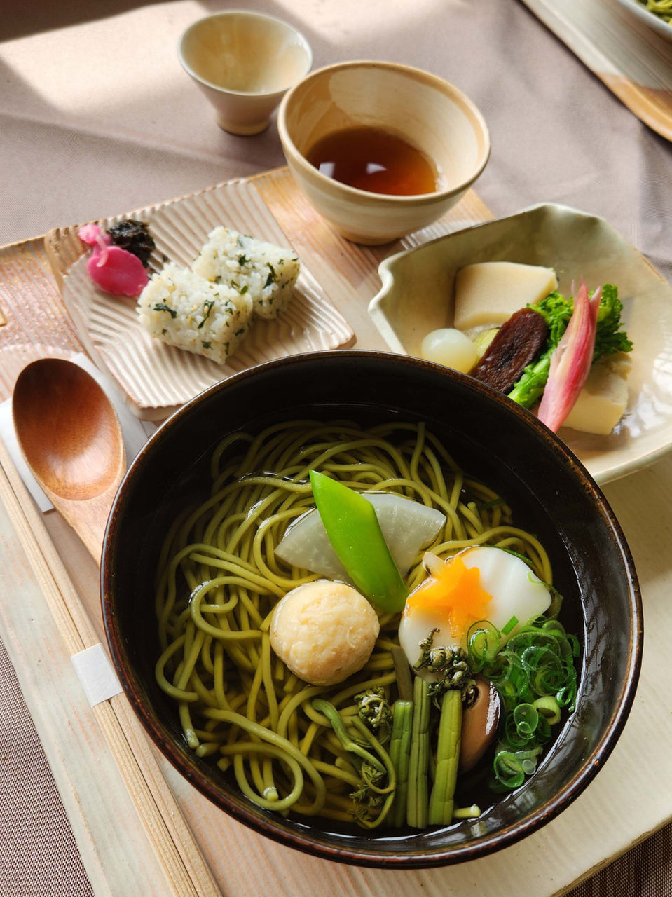Traditional Japanese meal with matcha soba noodles and side dishes on an FTLO trip