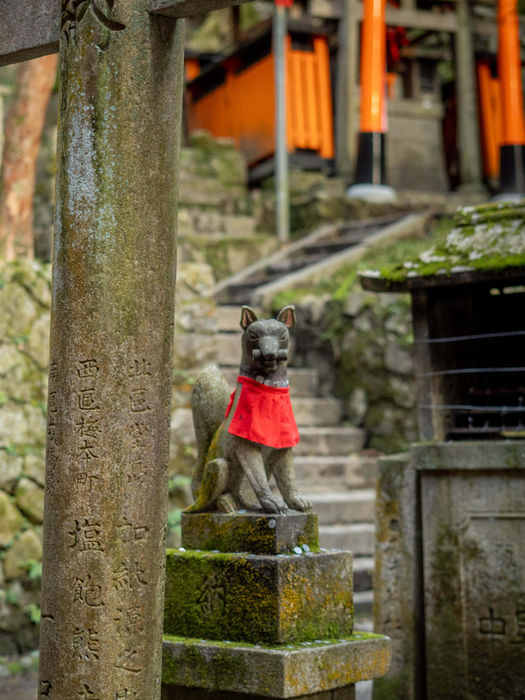 Stone fox statue at Fushimi Inari Shrine in Kyoto, Japan.
