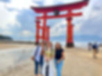Travelers at the floating Torii Gate of Itsukushima Shrine on Miyajima Island, Japan with FTLO Travel.