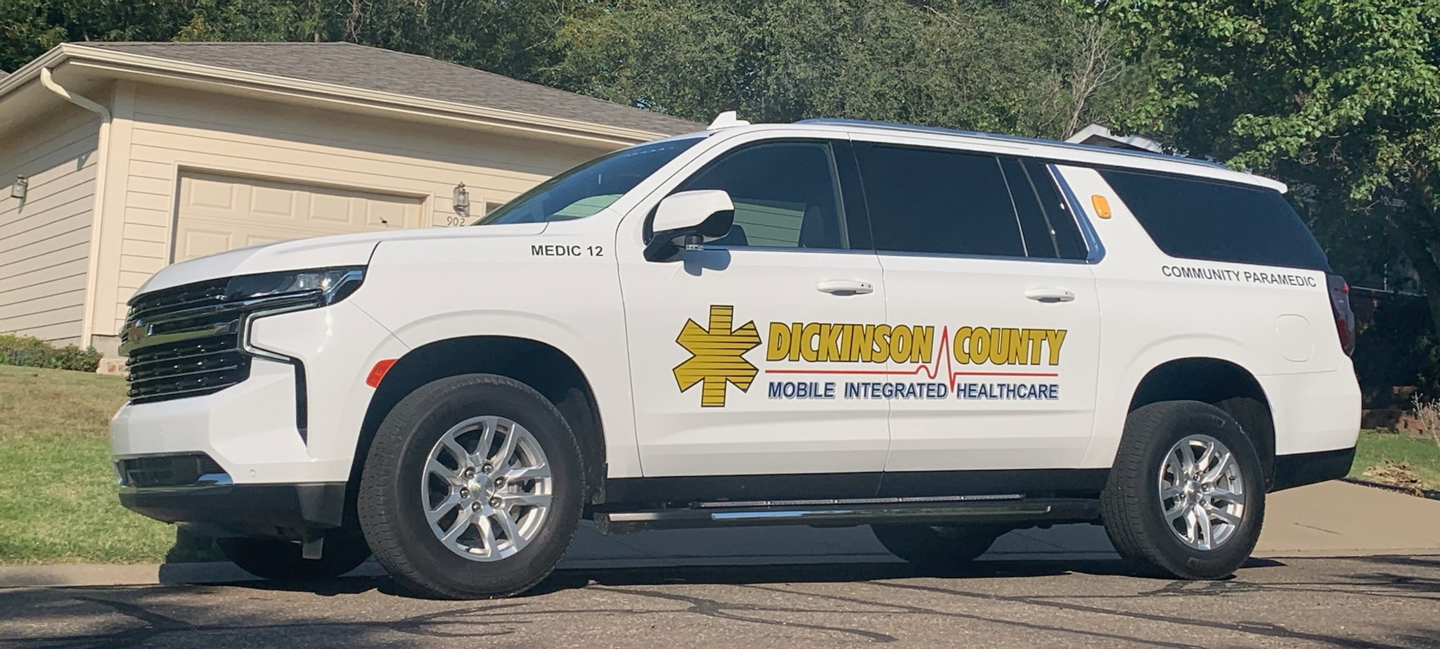 Dickinson County Mobile Integrated Healthcare community paramedic vehicle parked outside a resiedntial home.