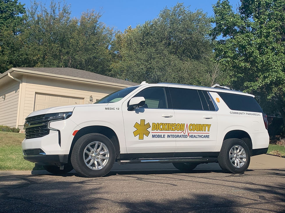 Dickinson County Mobile Integrated Healthcare community paramedic vehicle parked outside a resiedntial home.