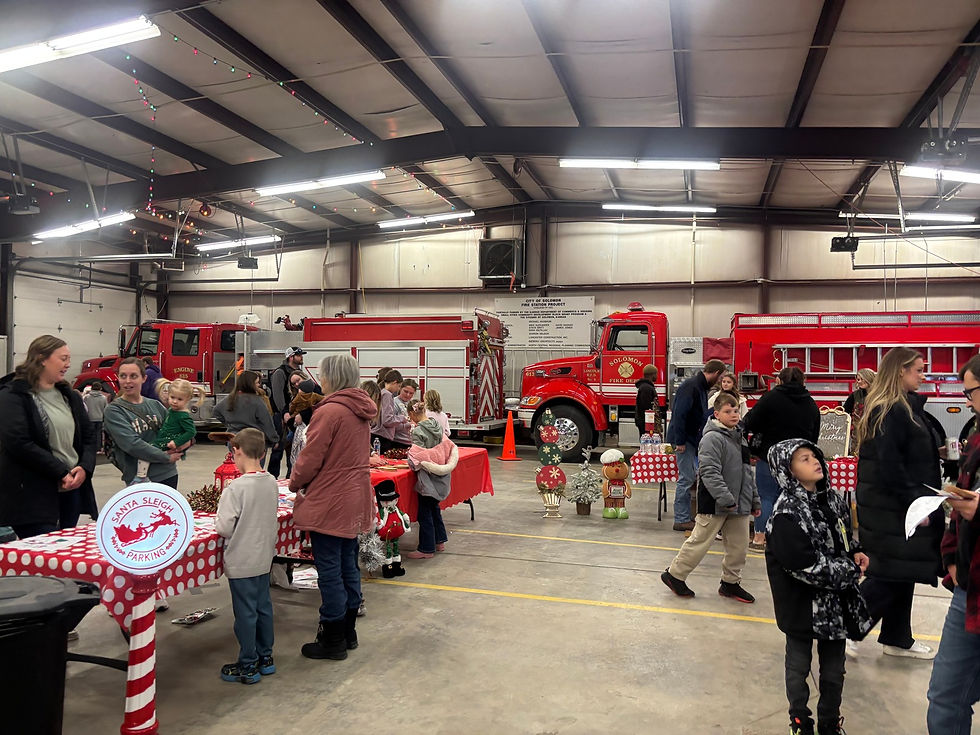 Families and volunteers gather inside the Solomon Fire Department during Community Christmas.