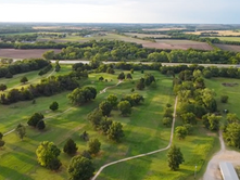 Aerial view of the Abilene Golf & Fitness golf course surrounded by trees and rural Kansas landscape.