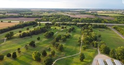 Aerial view of the Abilene Golf & Fitness golf course surrounded by trees and rural Kansas landscape.