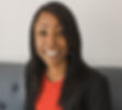Melanie Marshall wearing a rd dress and black suit jacket smiling at camera