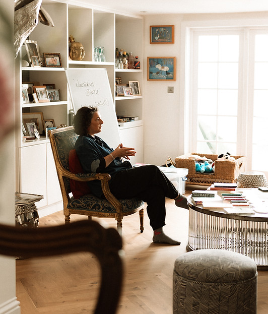 Sarah Sayer, founder of Nurturing Birth, leading a doula training session in a relaxed group setting.