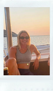 Woman relaxing on a sailboat deck at sunset during a Kite Cat sailing adventure trip