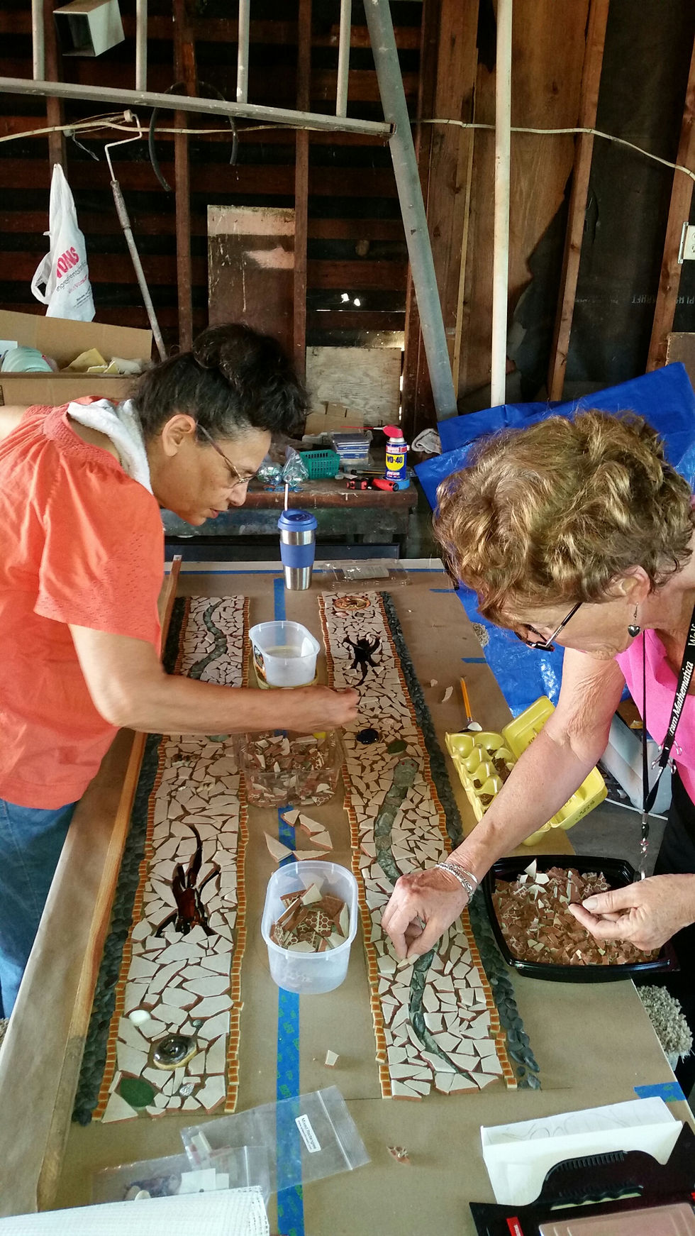 Community members building mosaics