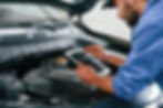 A technician performing a digital vehicle inspection.
