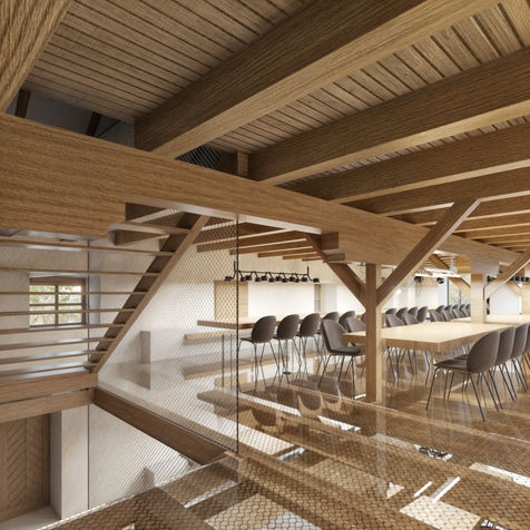 Multifunkční sál v podkroví sýpky s odkrytými trámy a dlouhým stolem.