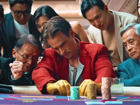 Collin Farrell as Lord Doyle at the baccarat table with his lucky yellow gloves